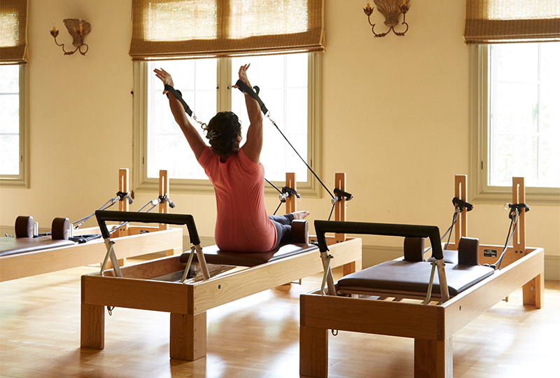 a woman on a reformer