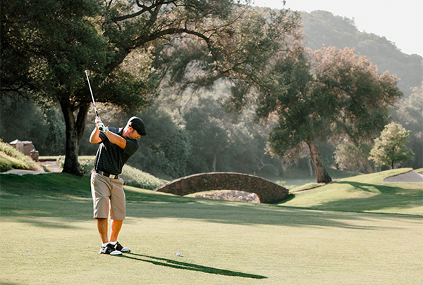 a man swinging a golf club