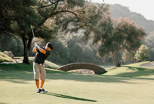 a man swinging a golf club