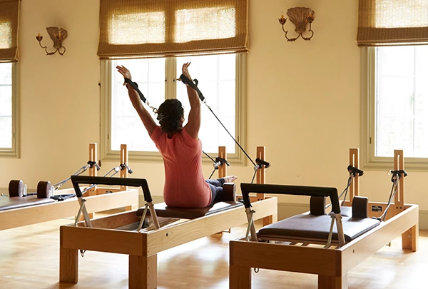 a woman on a reformer