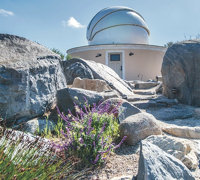 a building with a dome and rocks