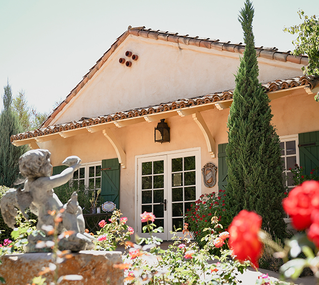 a house with a garden and a statue
