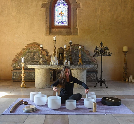 a woman sitting in a room with white bowls