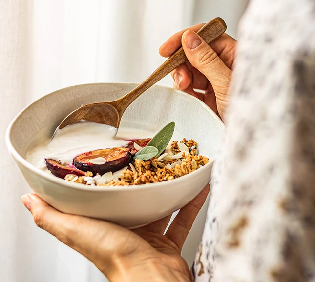 a person holding a bowl of food