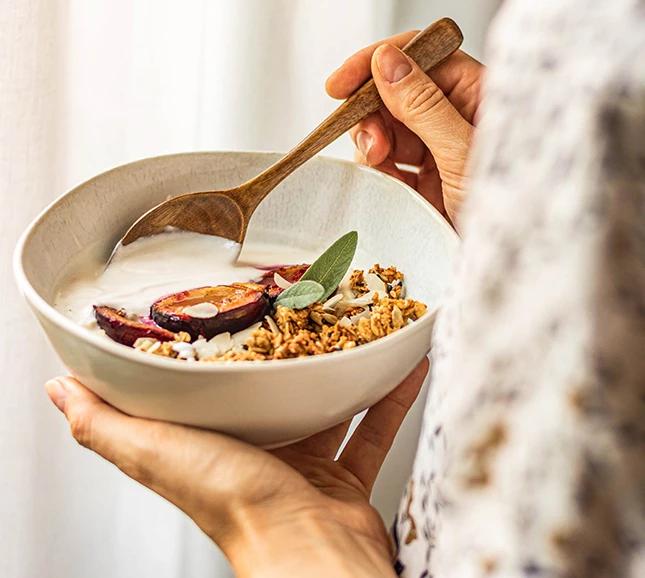 a person holding a bowl of food