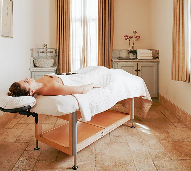 a woman lying on a massage table