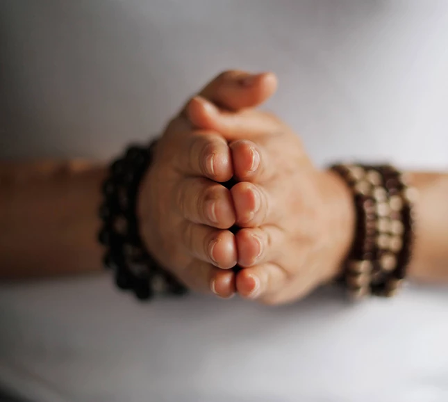 a person's hands with bracelets