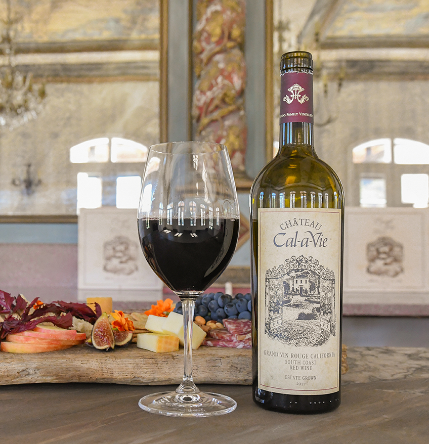 a bottle of wine next to a glass of wine