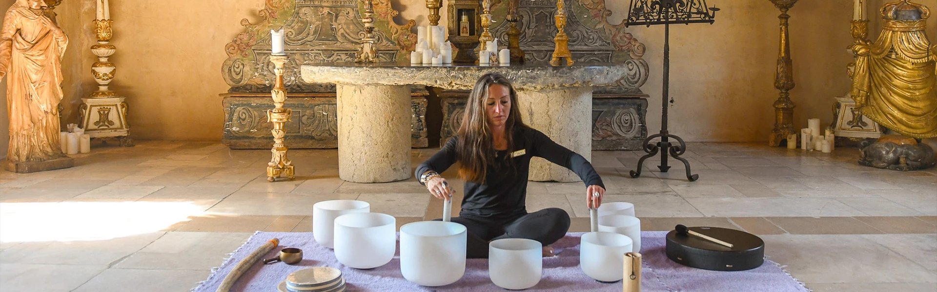 a woman sitting on the floor with white bowls
