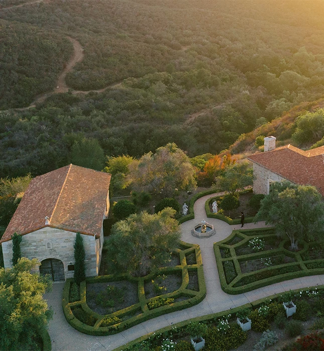 a landscape with a garden and a house