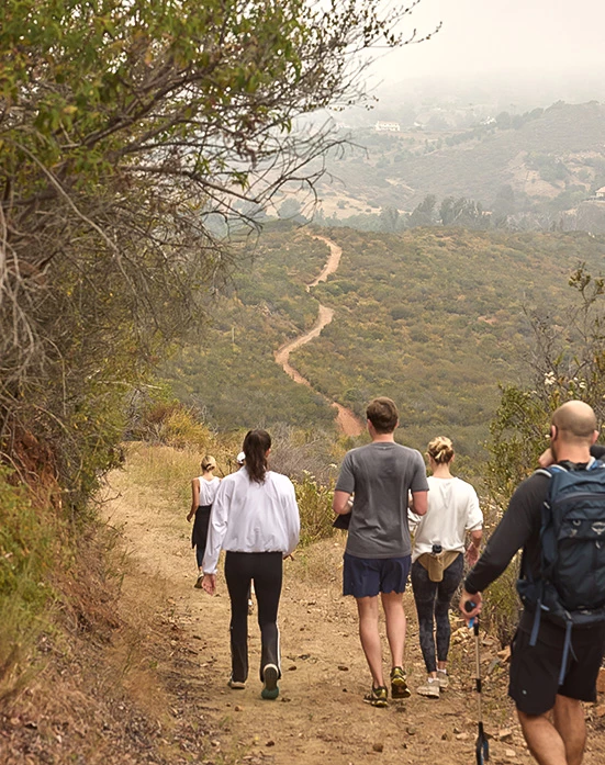 a group of people walking on a trail