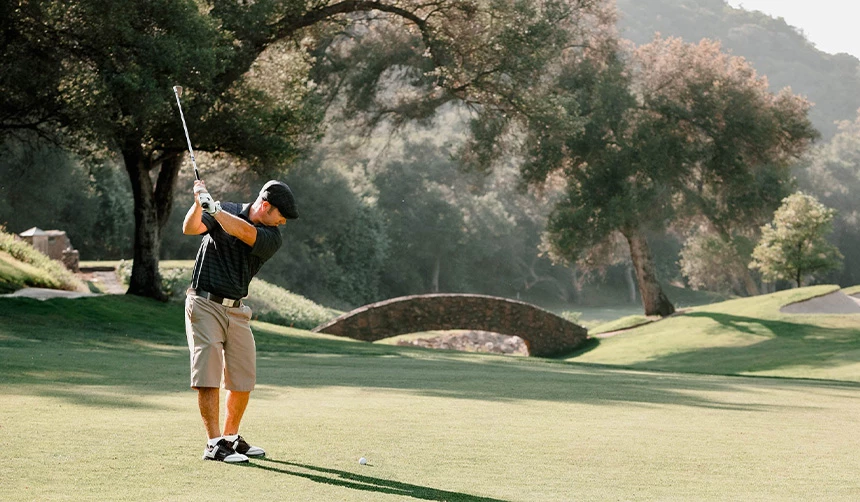 a man swinging a golf club
