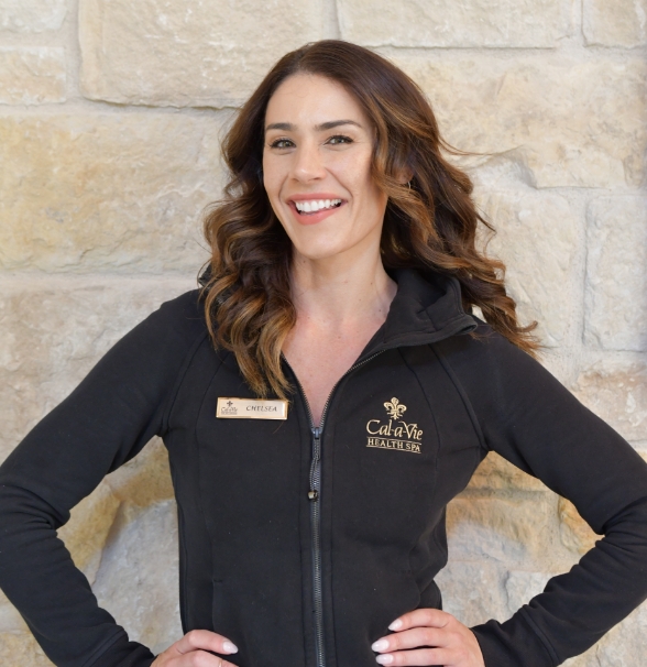 a woman smiling with her hands on her hips