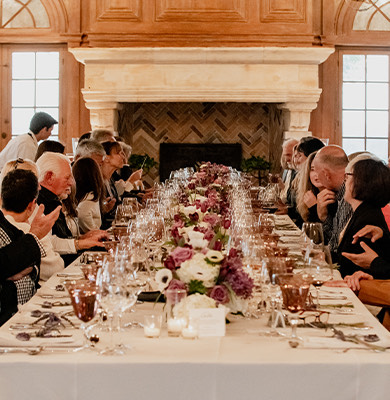 a group of people sitting at a table with wine glasses