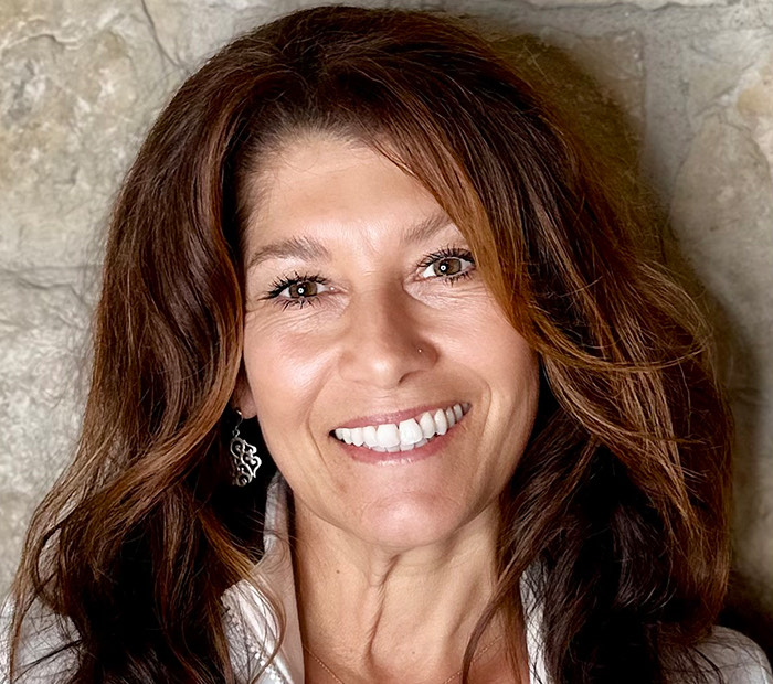 a woman with long hair smiling