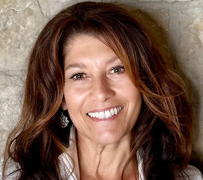 a woman with long hair smiling