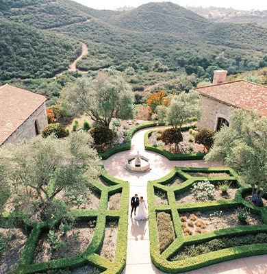 a couple walking down a path in a beautiful landscape
