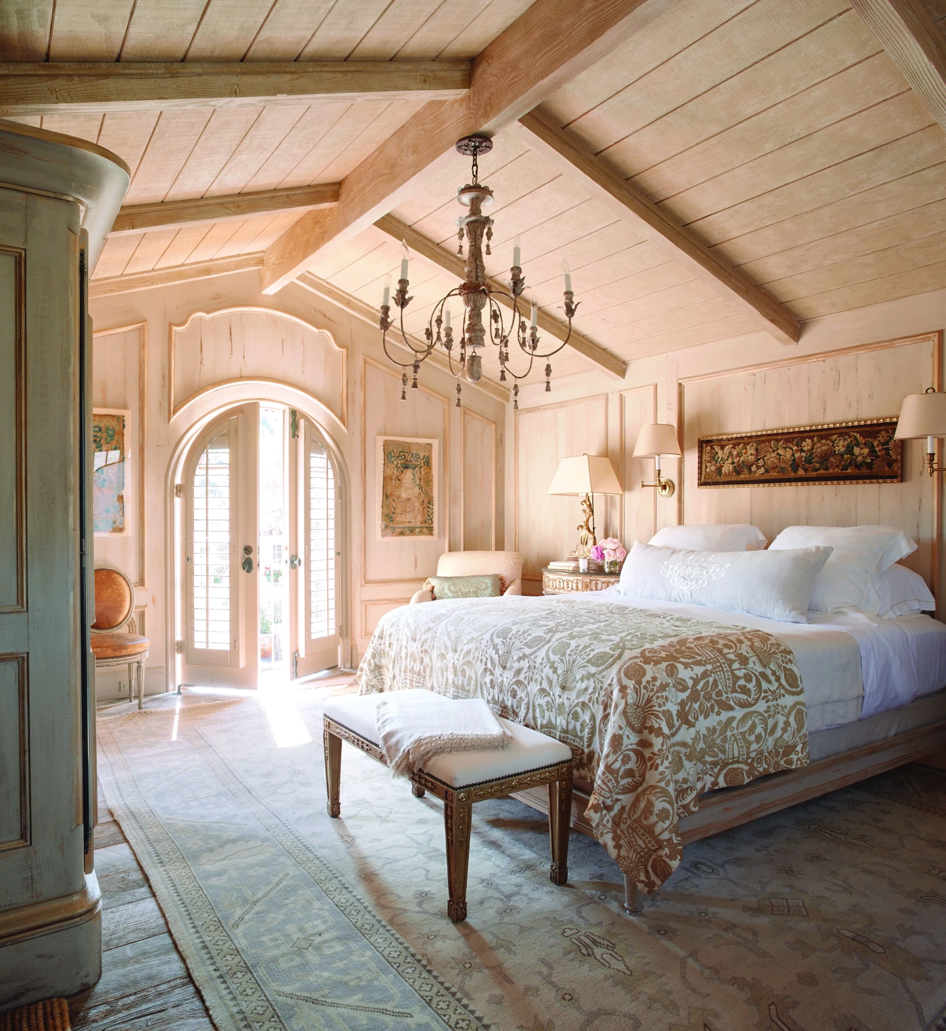 a bedroom with a bed and a chandelier