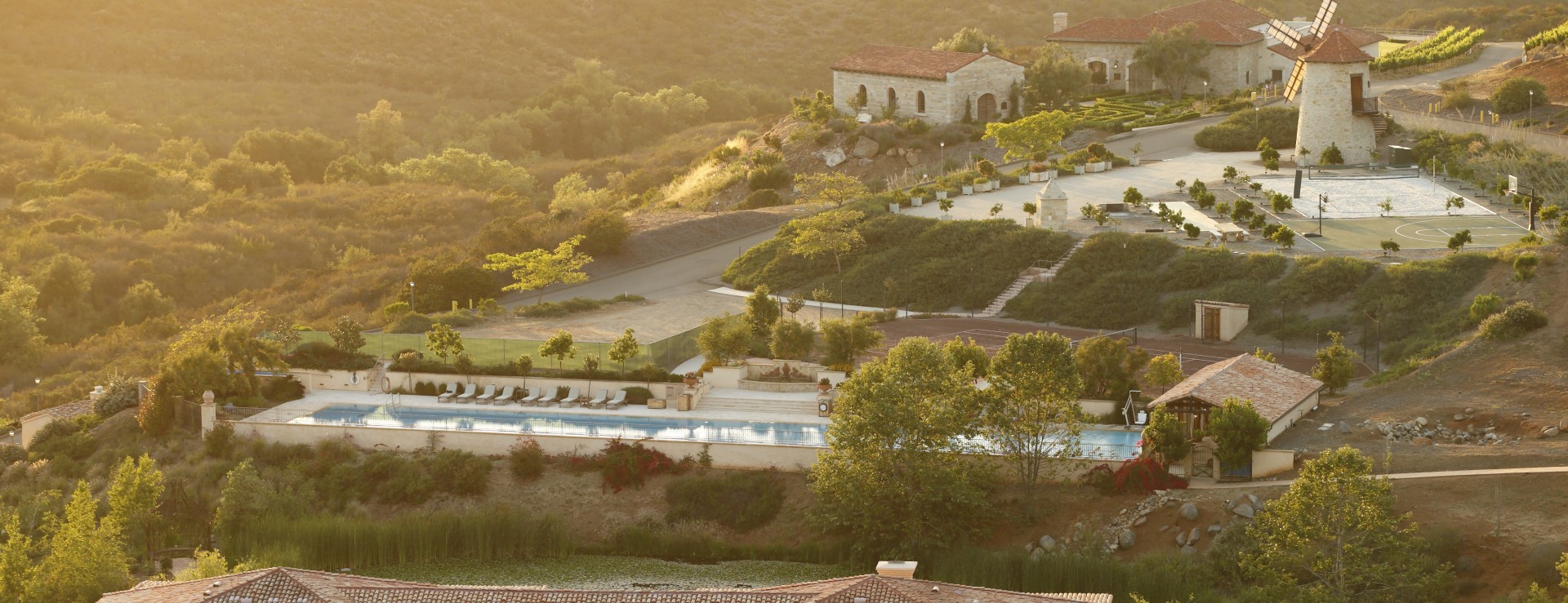 a pool and a building on a hill