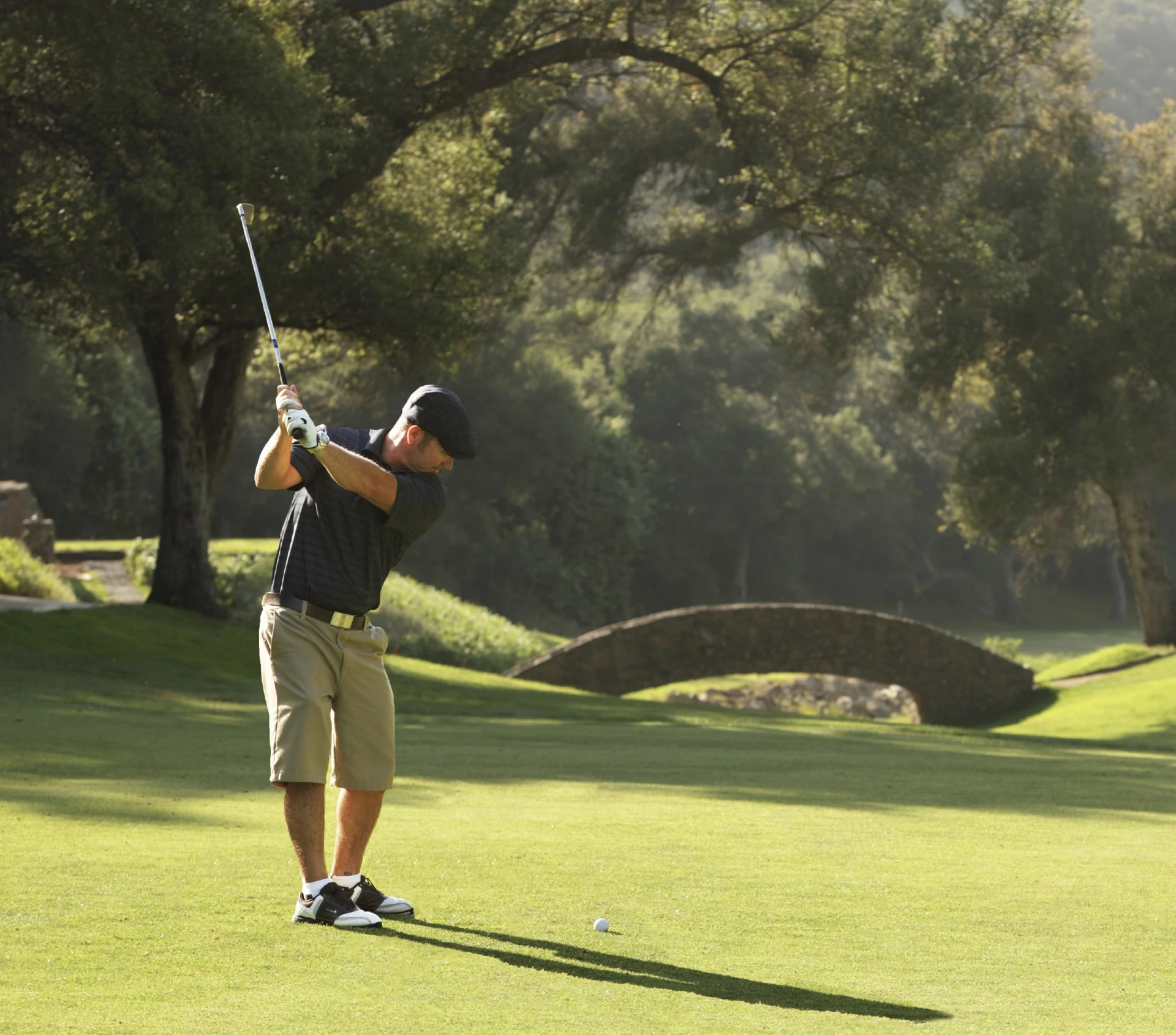 a man swinging a golf club