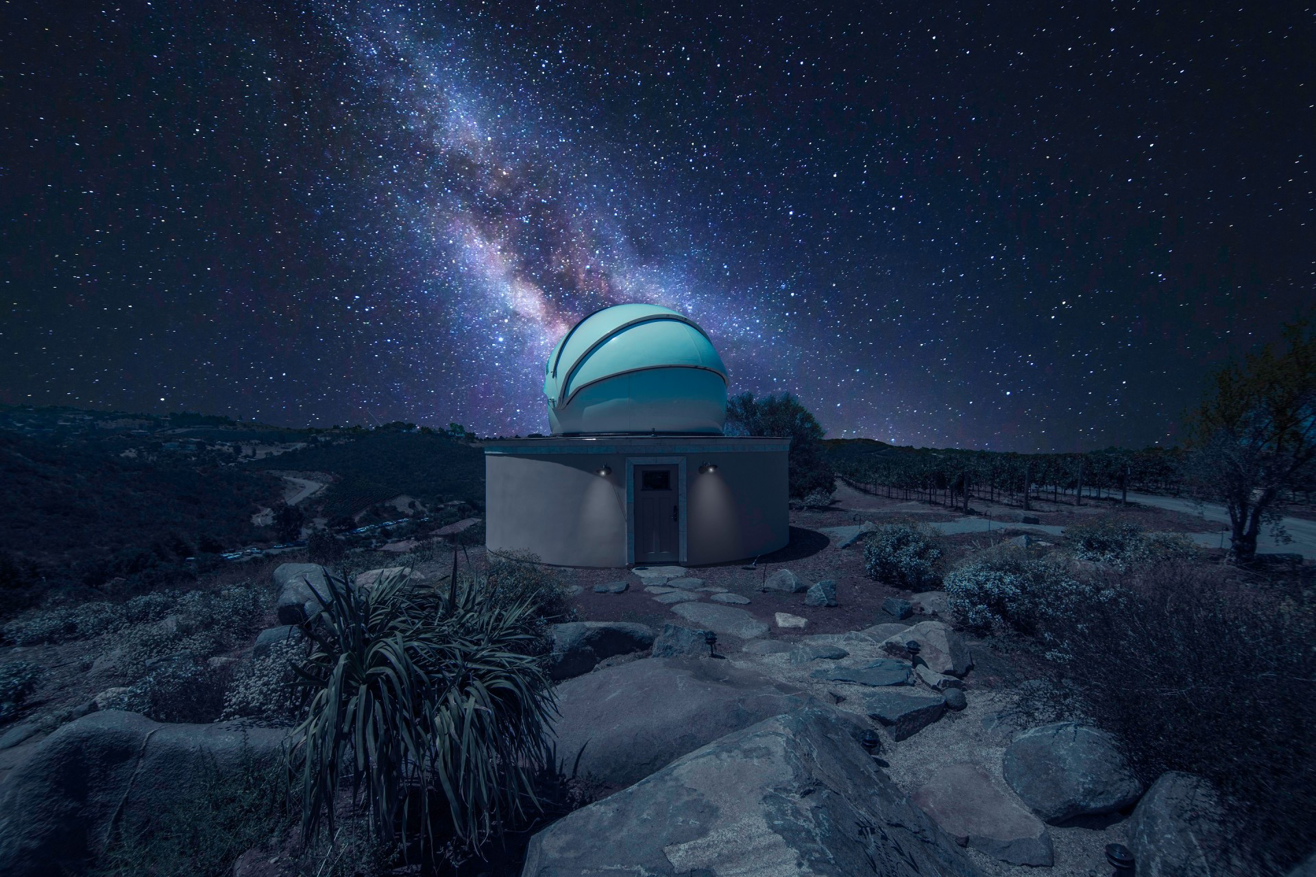 a building with a dome in the middle of a field with stars
