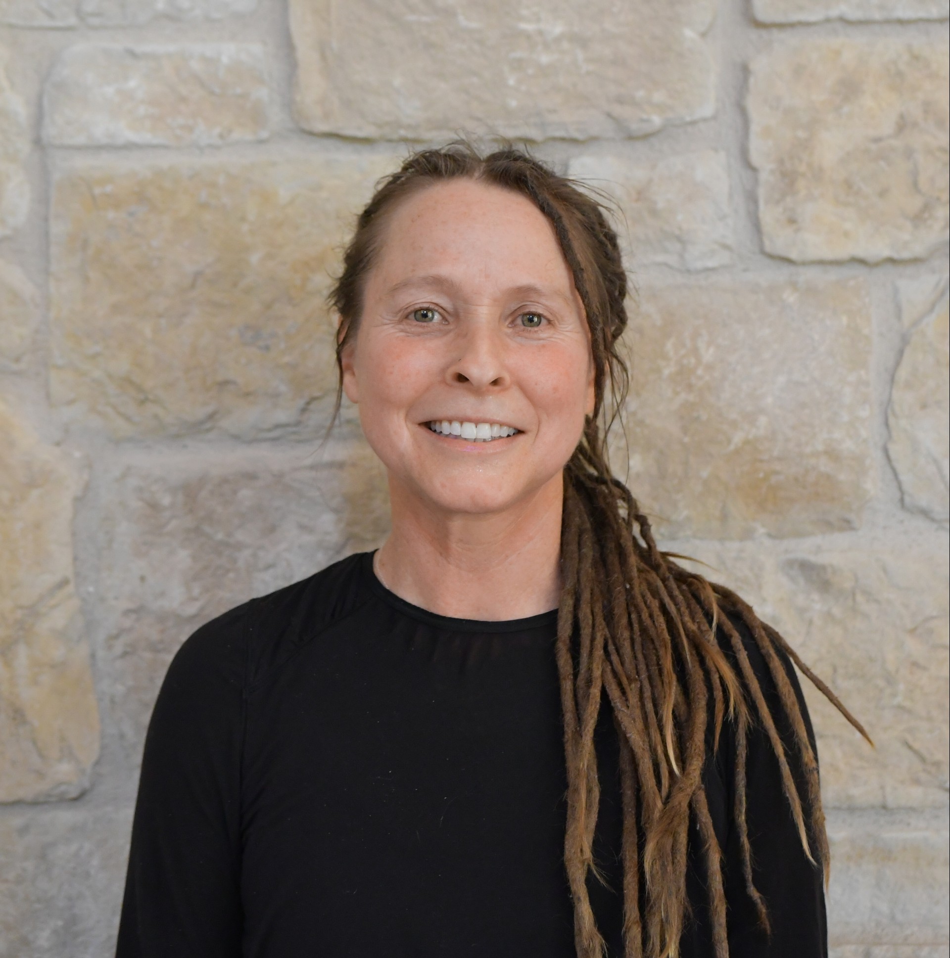 a woman with dreadlocks smiling