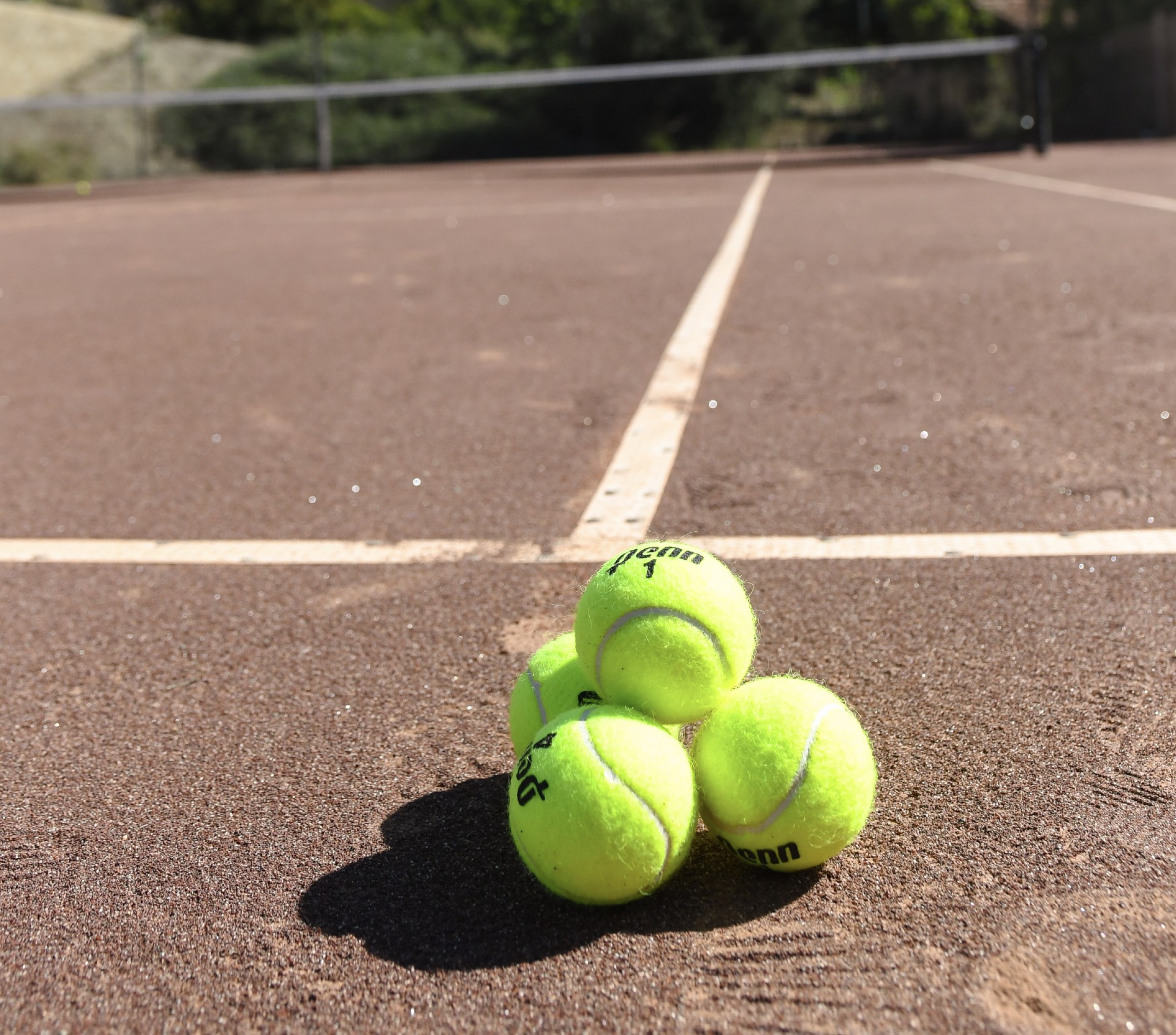 a group of tennis balls on a tennis court