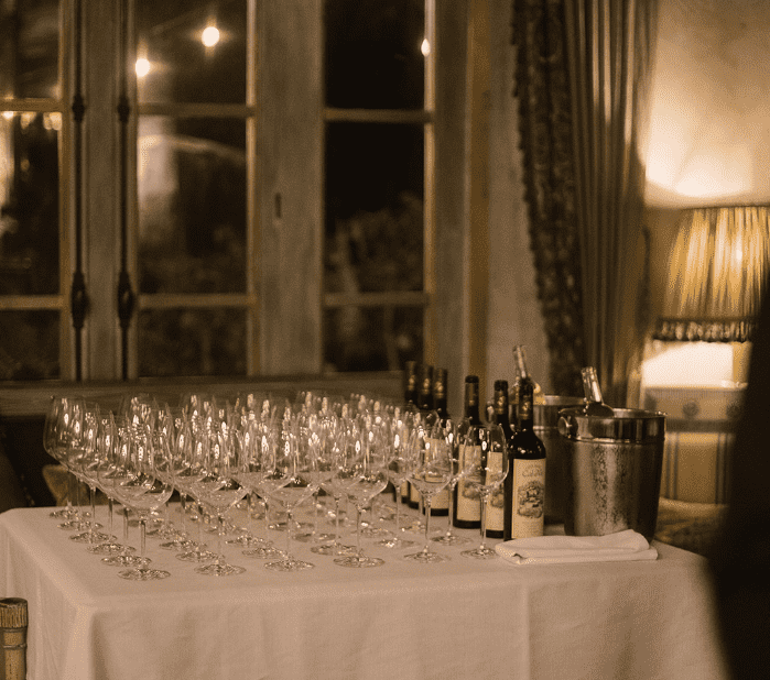 a table with wine glasses and bottles on it