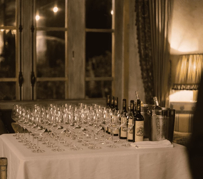 a table with wine glasses and bottles on it