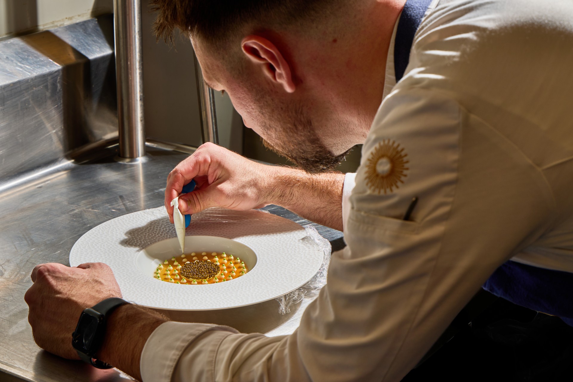 a man decorating a plate