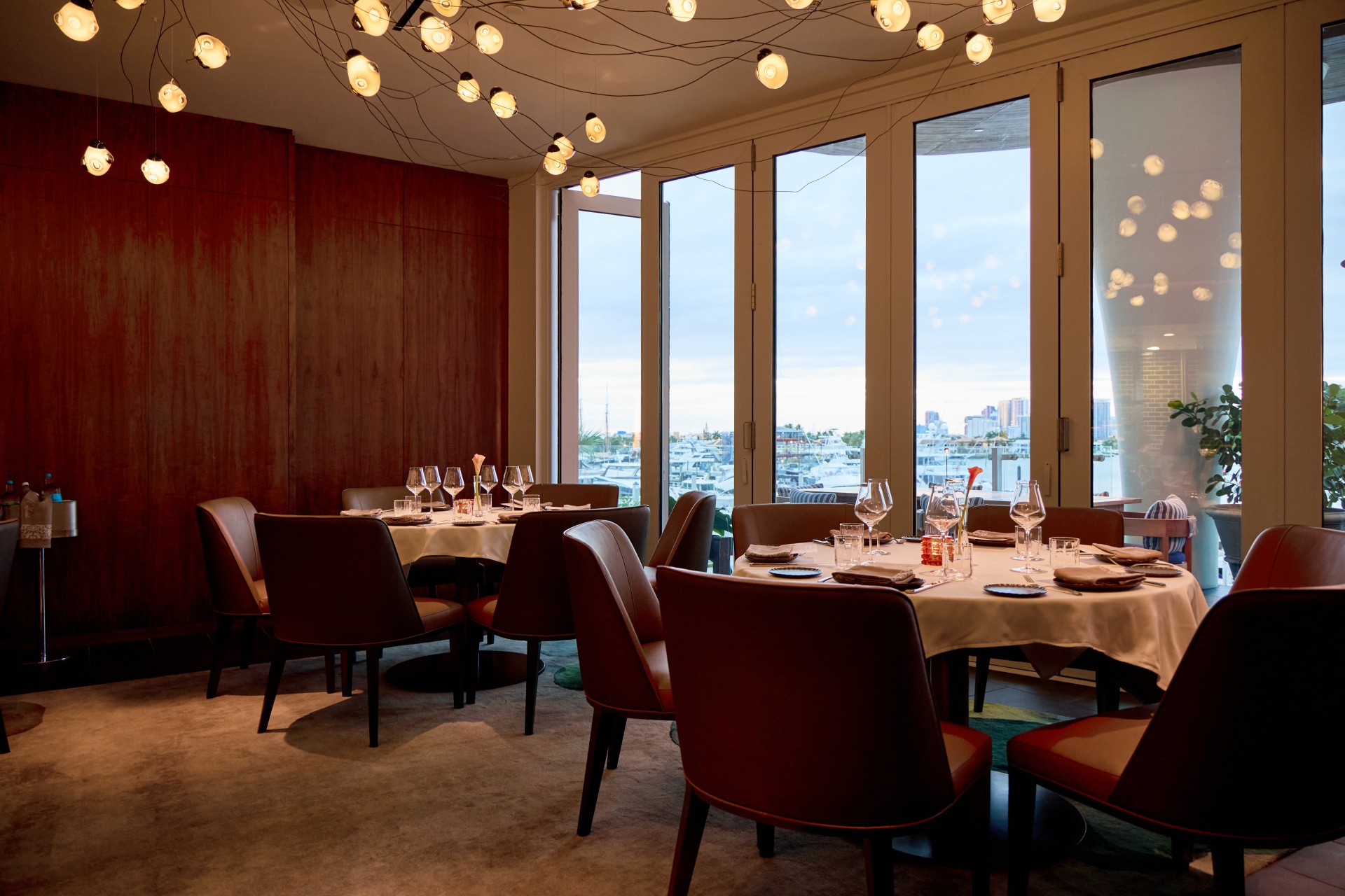 a room with a table and chairs and a chandelier