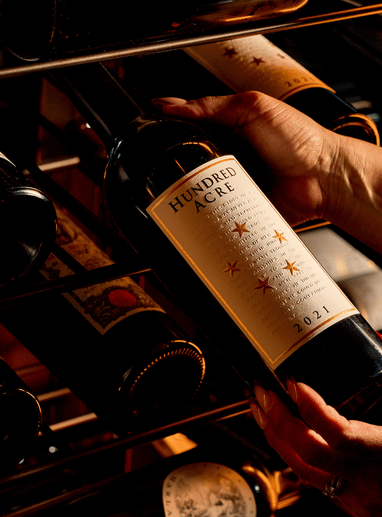 a person holding a bottle of wine