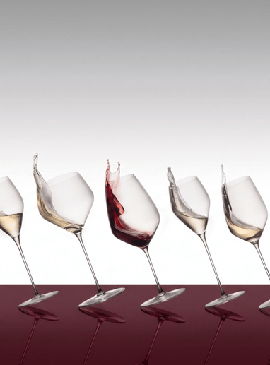 a group of wine glasses with a splash