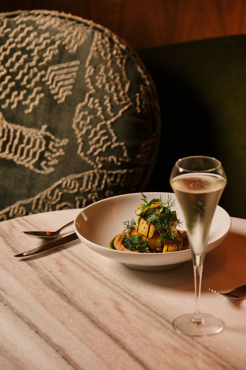 a plate of food and a glass of champagne