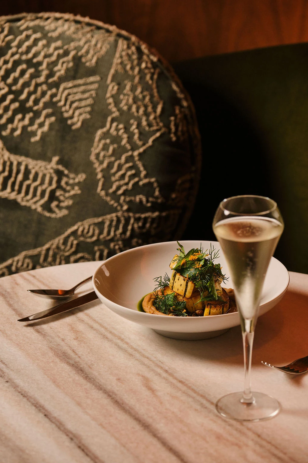 a plate of food and a glass of champagne