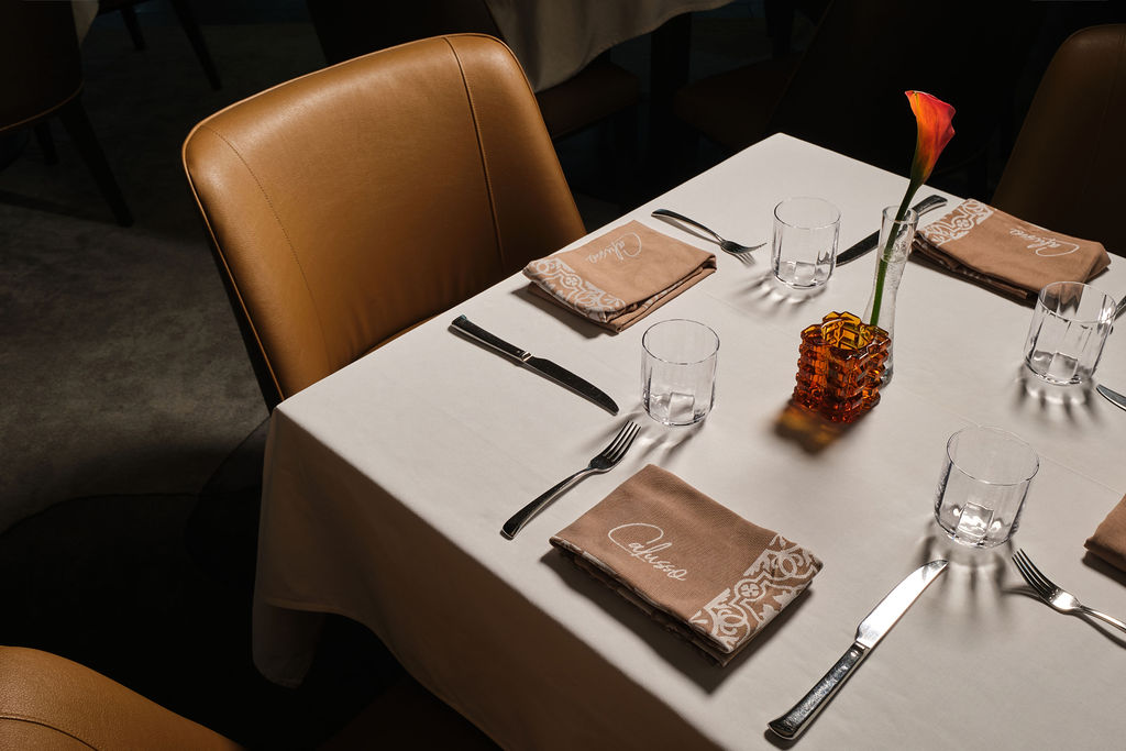 a table with utensils and glasses
