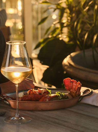 a glass of wine and a plate of food