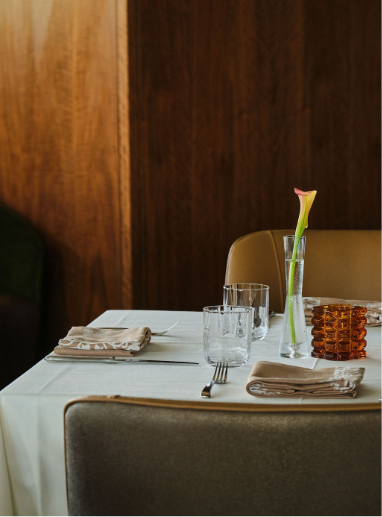 a table with glasses and a flower in it