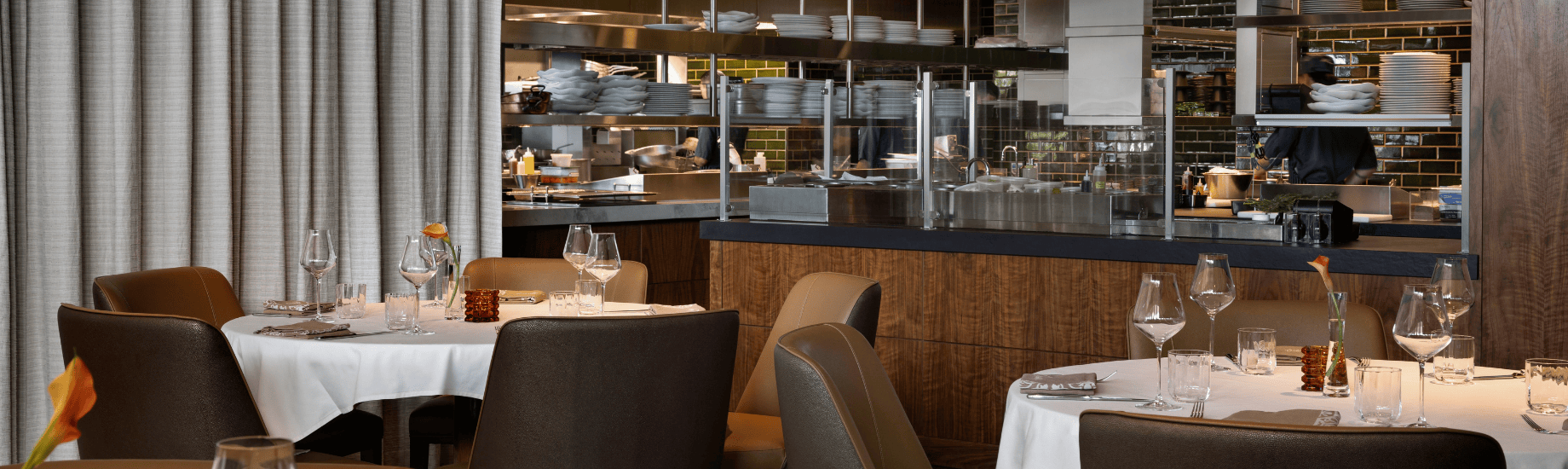 a restaurant with a counter and shelves of plates