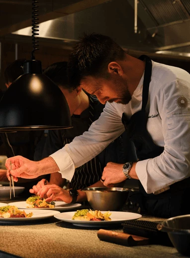 a man in a chef's uniform preparing food