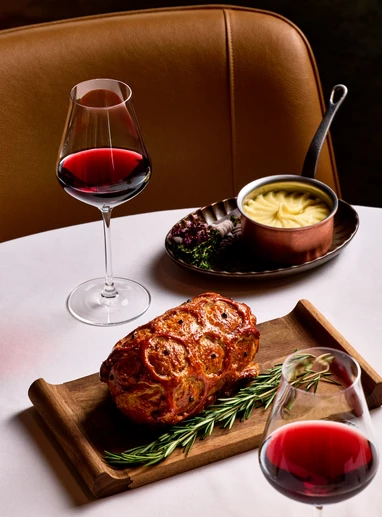 a plate of food and a glass of wine