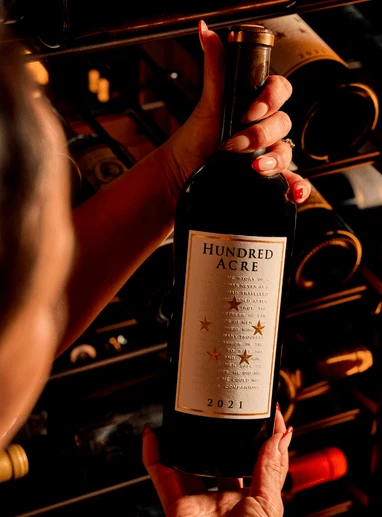 a person holding a bottle of wine