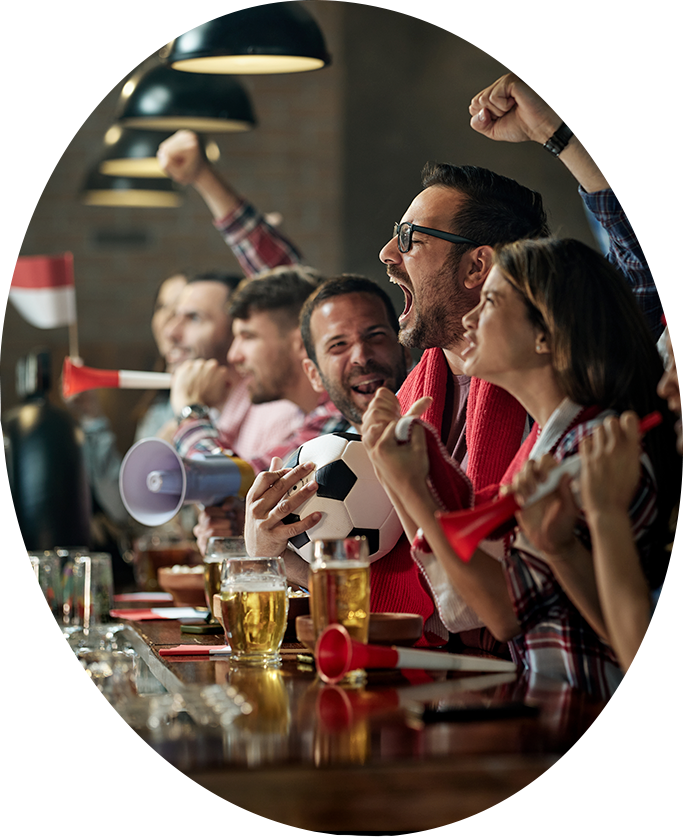a group of people cheering at a bar