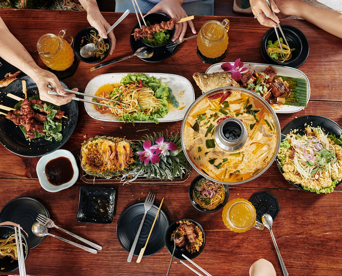 a group of people eating food at a table