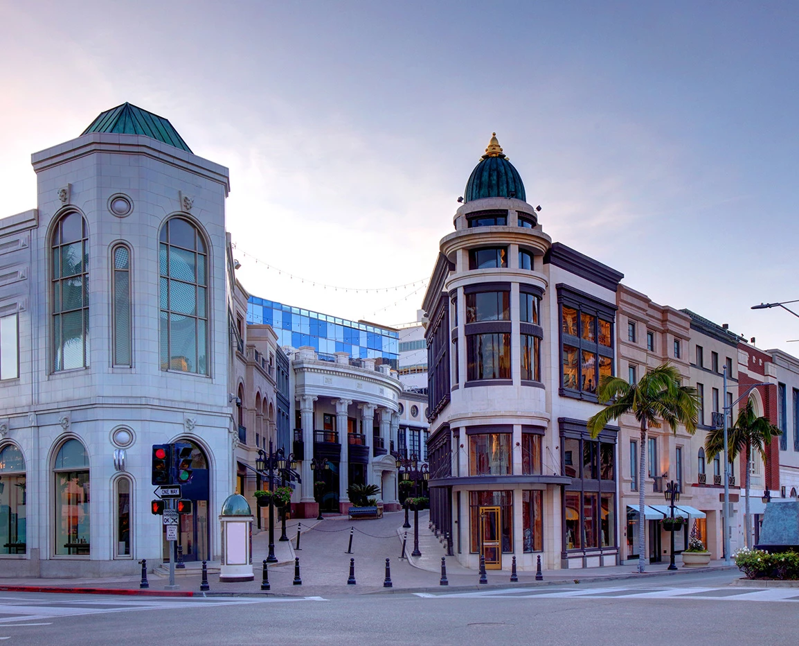a street with buildings and palm trees