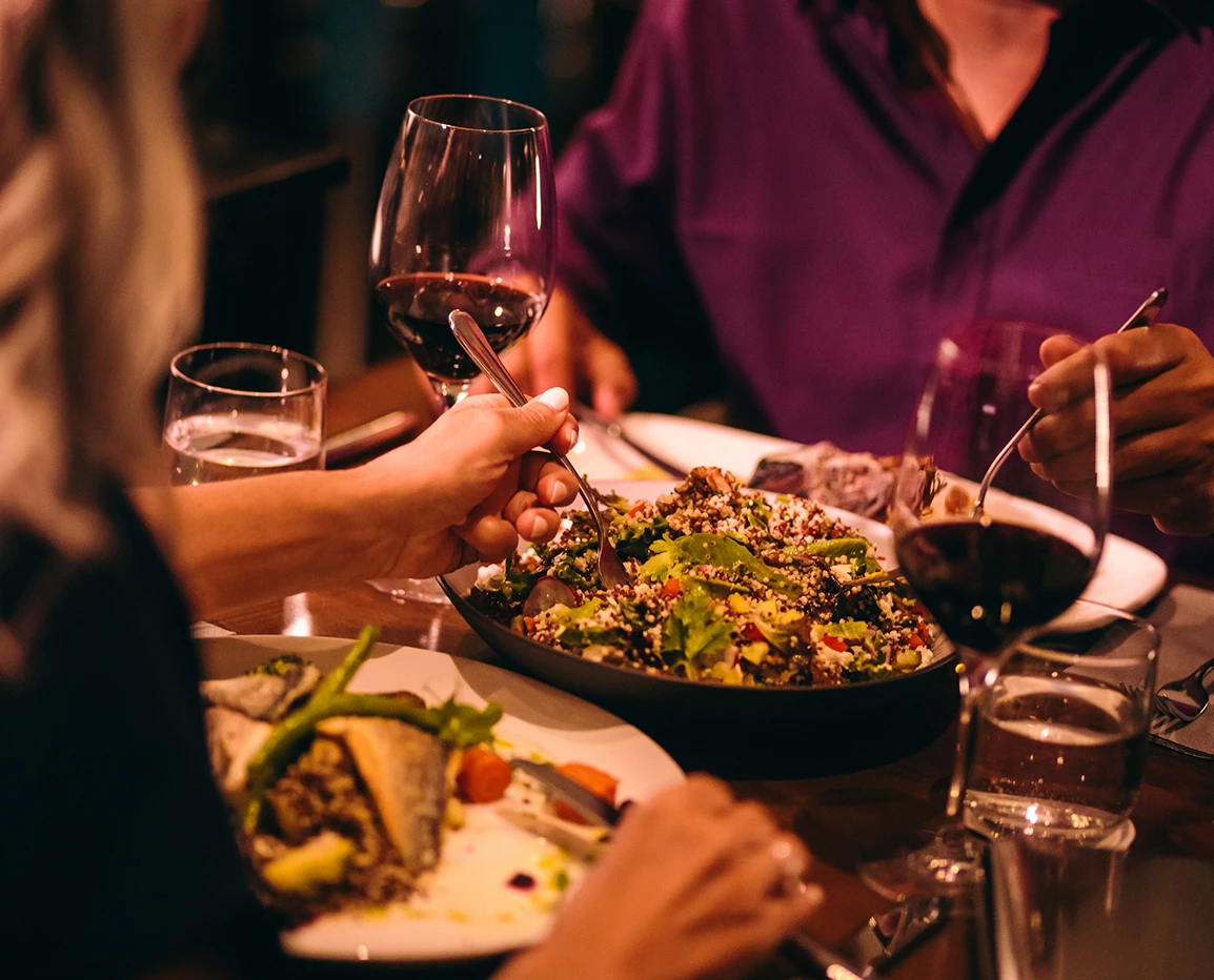 a group of people eating food at a table