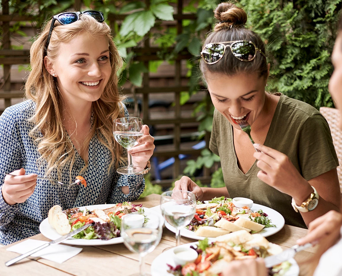 a group of women eating at a table