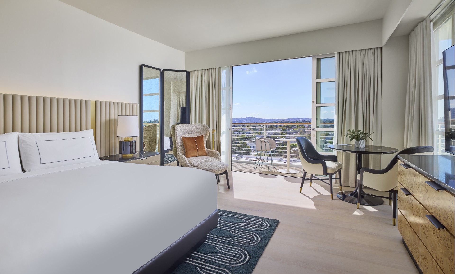 a room with a bed and chairs and a table