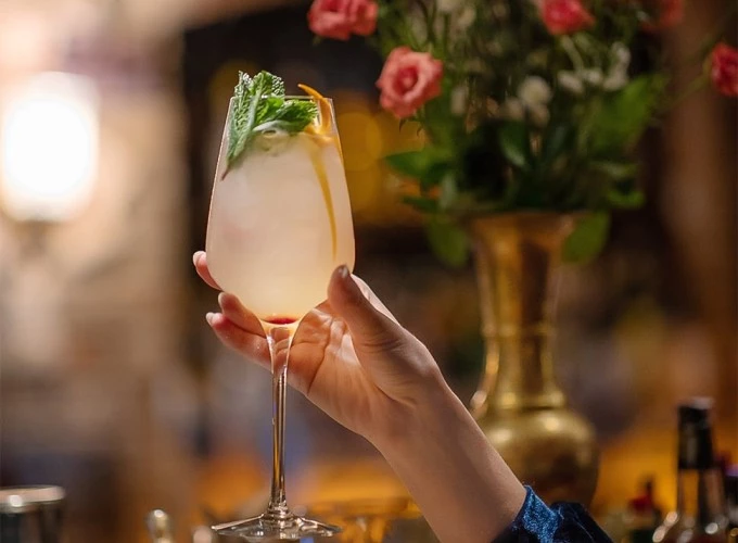 a hand holding a glass of champagne