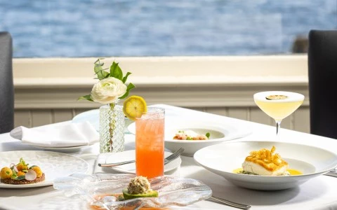 a table with plates of food and drinks on it